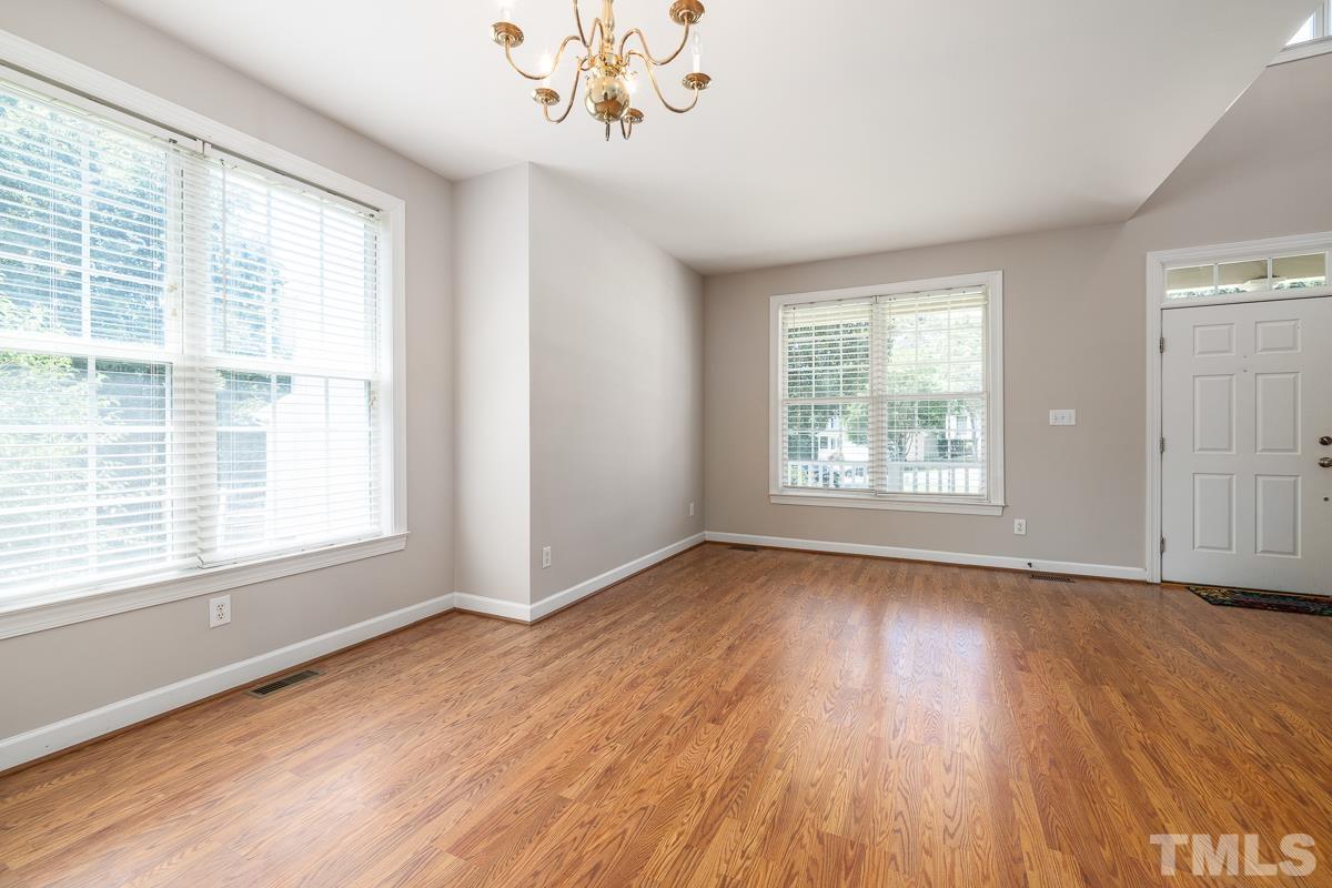 3308 Heygill Lane Raleigh, NC 27604 - Photo 9 of 18 an empty room with wooden floor and windows