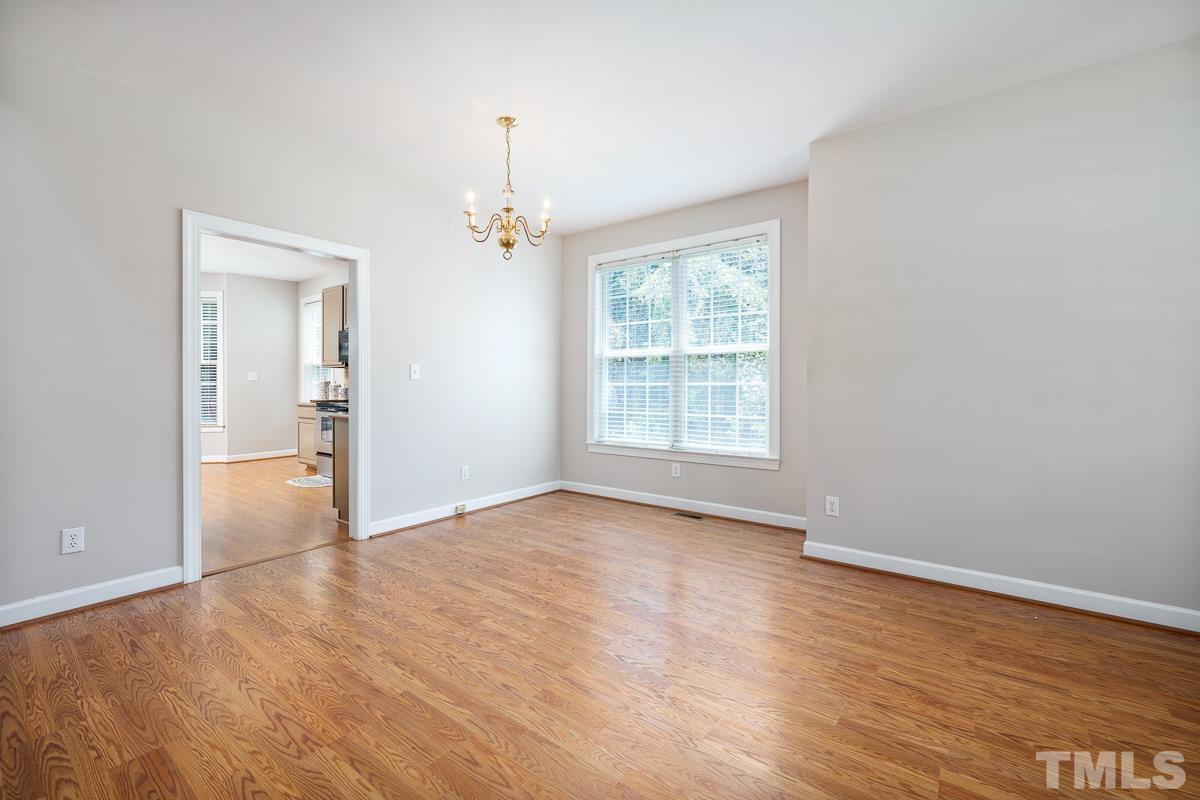 3308 Heygill Lane Raleigh, NC 27604 - Photo 10 of 18 wooden floor in an empty room with a window