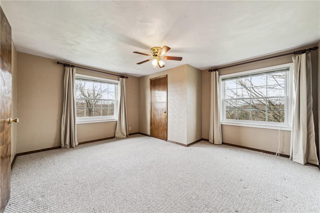 587 McKee Road Washington, PA 15301 - Photo 24 of 38 an empty room with chandelier fan and windows