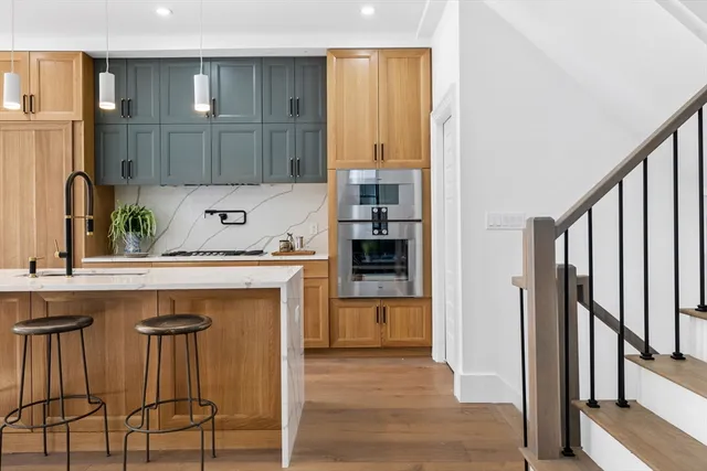 a kitchen with a sink a refrigerator and cabinets