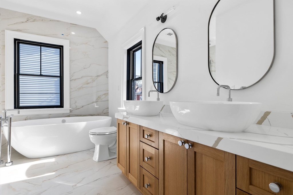 72 Oxford Street, Unit 72 Cambridge, MA 02138 - Photo 6 of 9 a bathroom with a sink a toilet and a mirror
