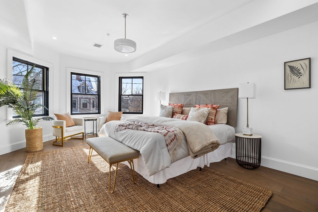 72 Oxford Street, Unit 72 Cambridge, MA 02138 - Photo 8 of 9 a spacious bedroom with a bed a couch and a window