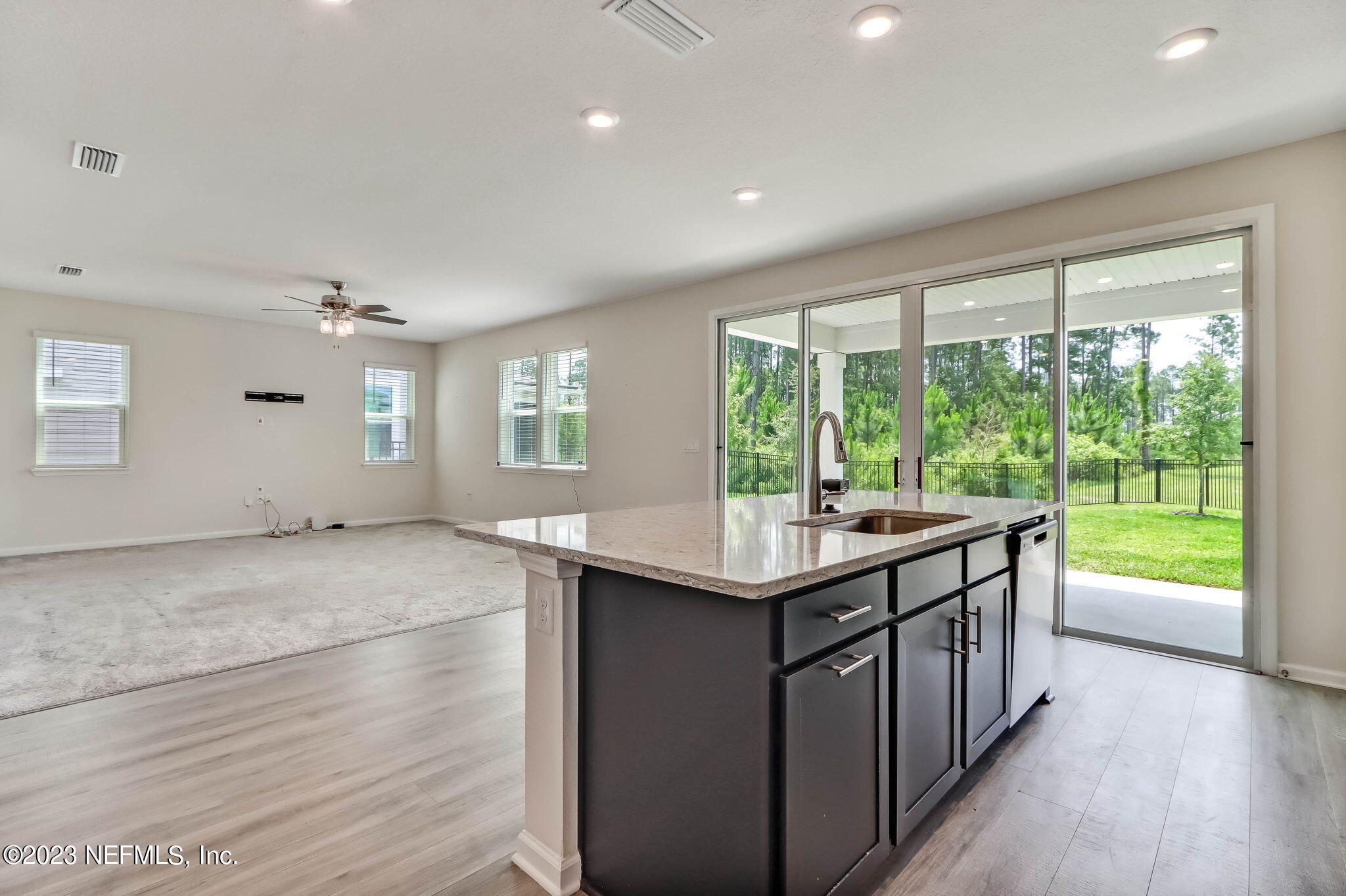 75944 Saffron Lane Yulee, FL 32097 - Photo 12 of 79 a kitchen with kitchen island a sink and wooden floor