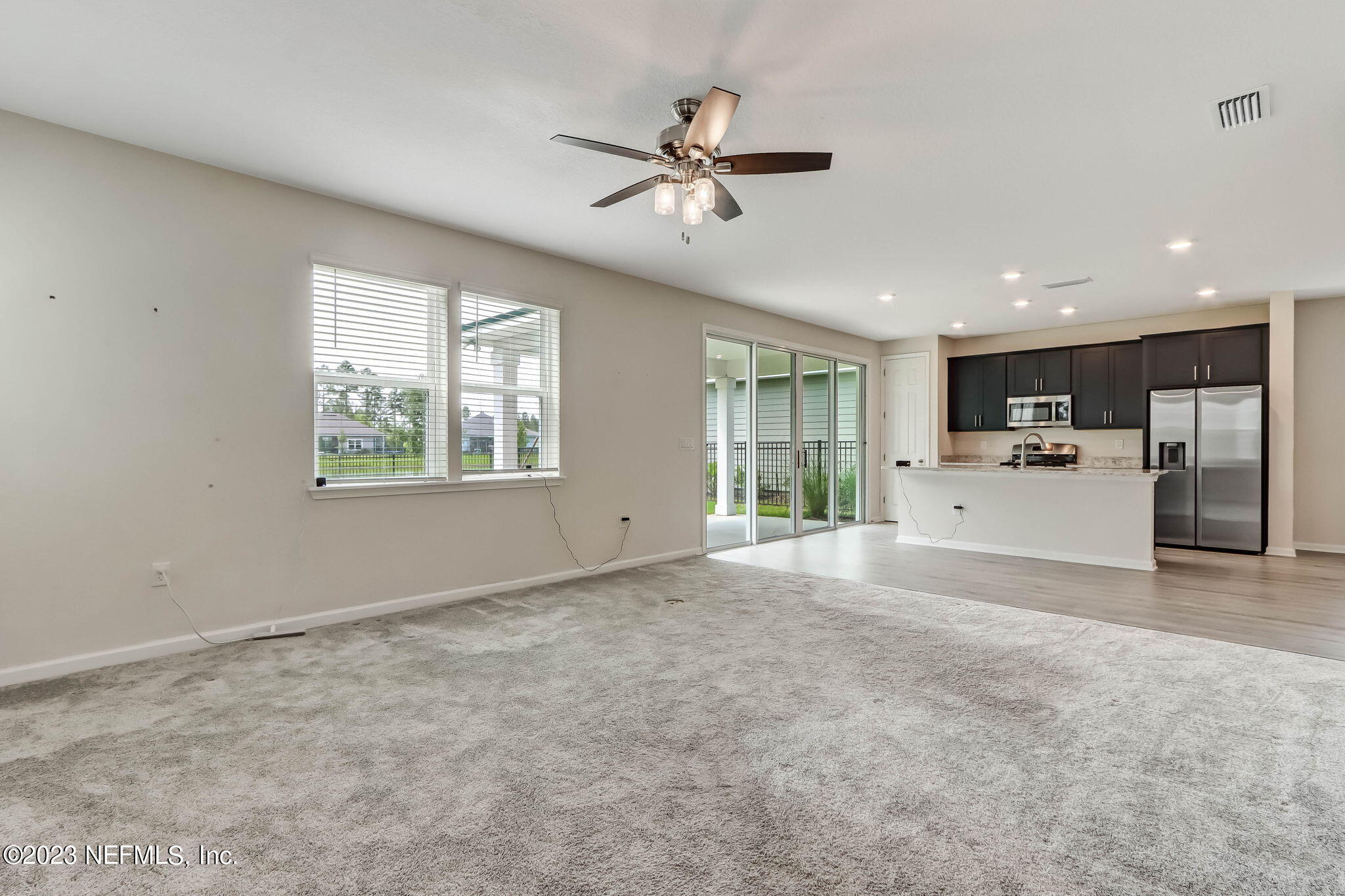 75944 Saffron Lane Yulee, FL 32097 - Photo 15 of 79 a view of a livingroom with furniture ceiling fan and window
