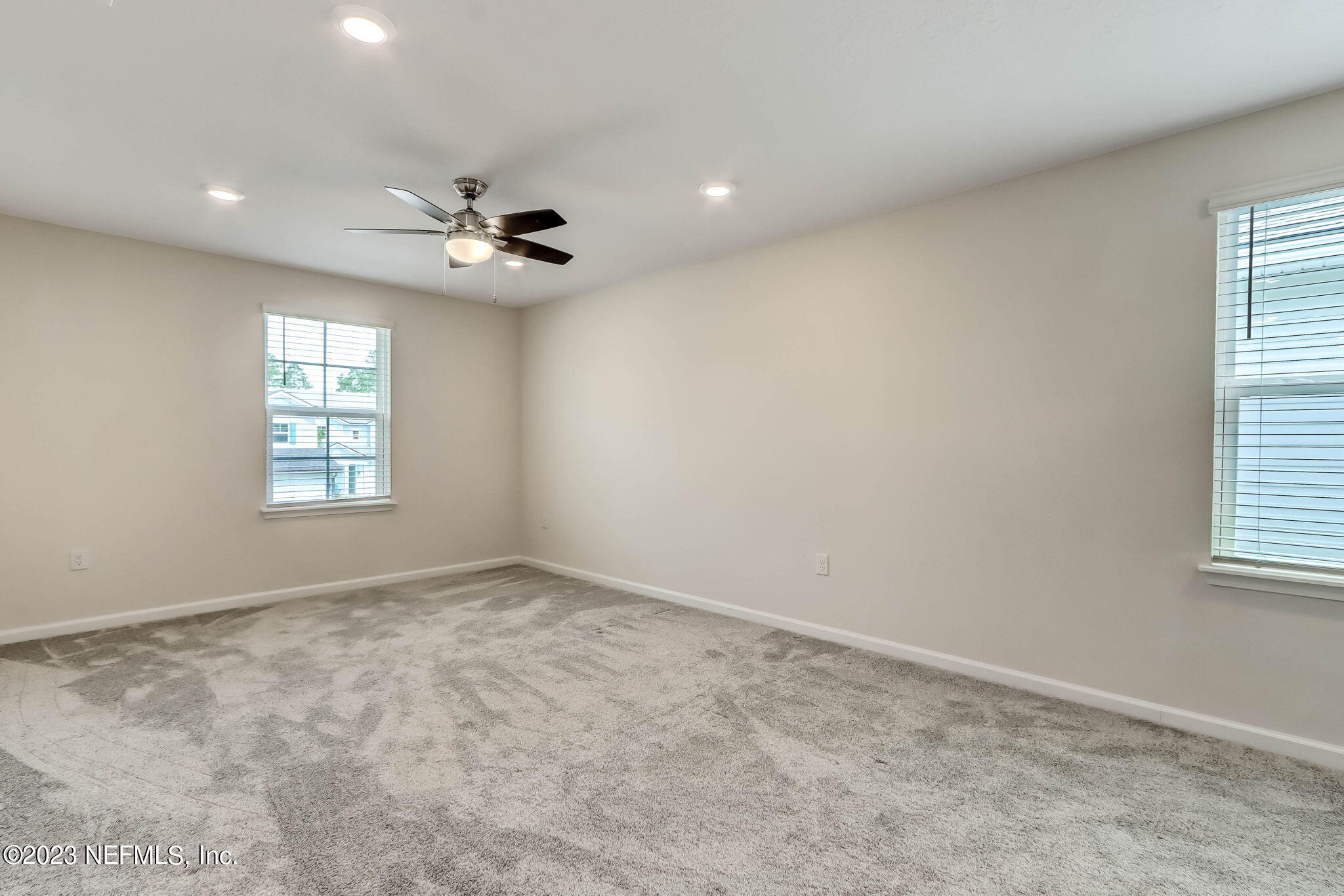 75944 Saffron Lane Yulee, FL 32097 - Photo 20 of 79 an empty room with windows and ceiling fan