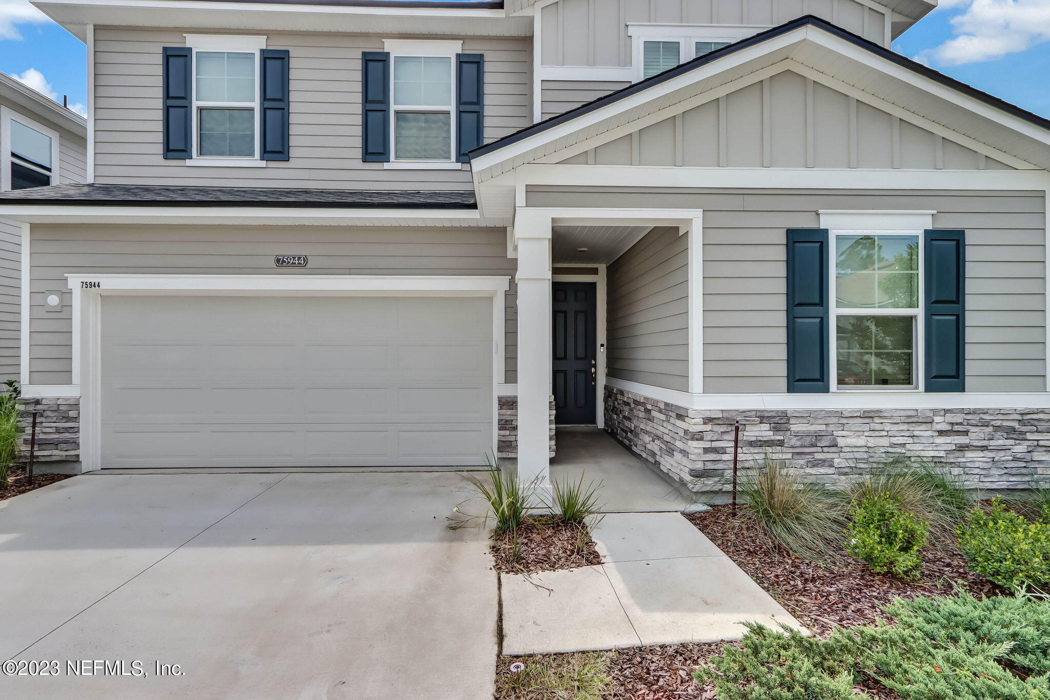 75944 Saffron Lane Yulee, FL 32097 - Photo 2 of 79 a front view of a house with a yard