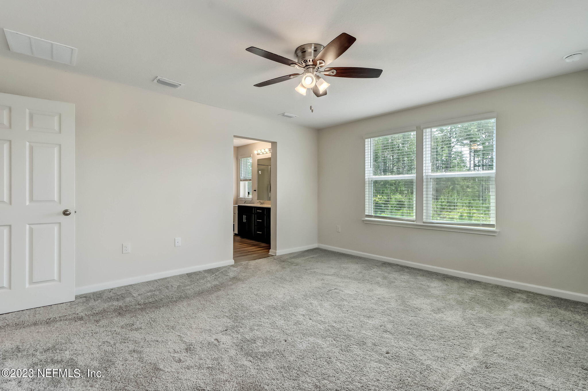 75944 Saffron Lane Yulee, FL 32097 - Photo 22 of 79 an empty room with windows and ceiling fan