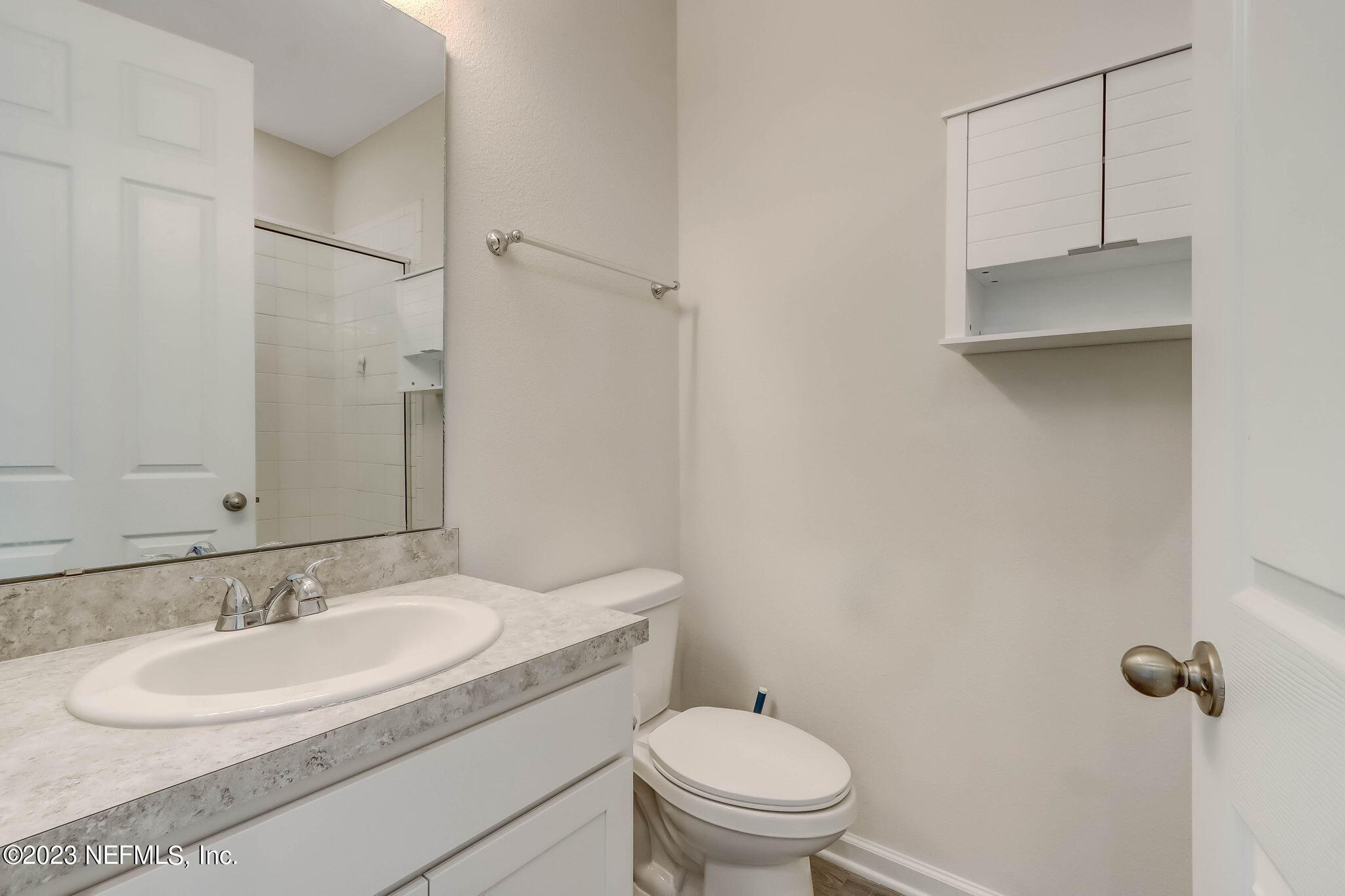 75944 Saffron Lane Yulee, FL 32097 - Photo 28 of 79 a bathroom with a granite countertop sink toilet and a mirror