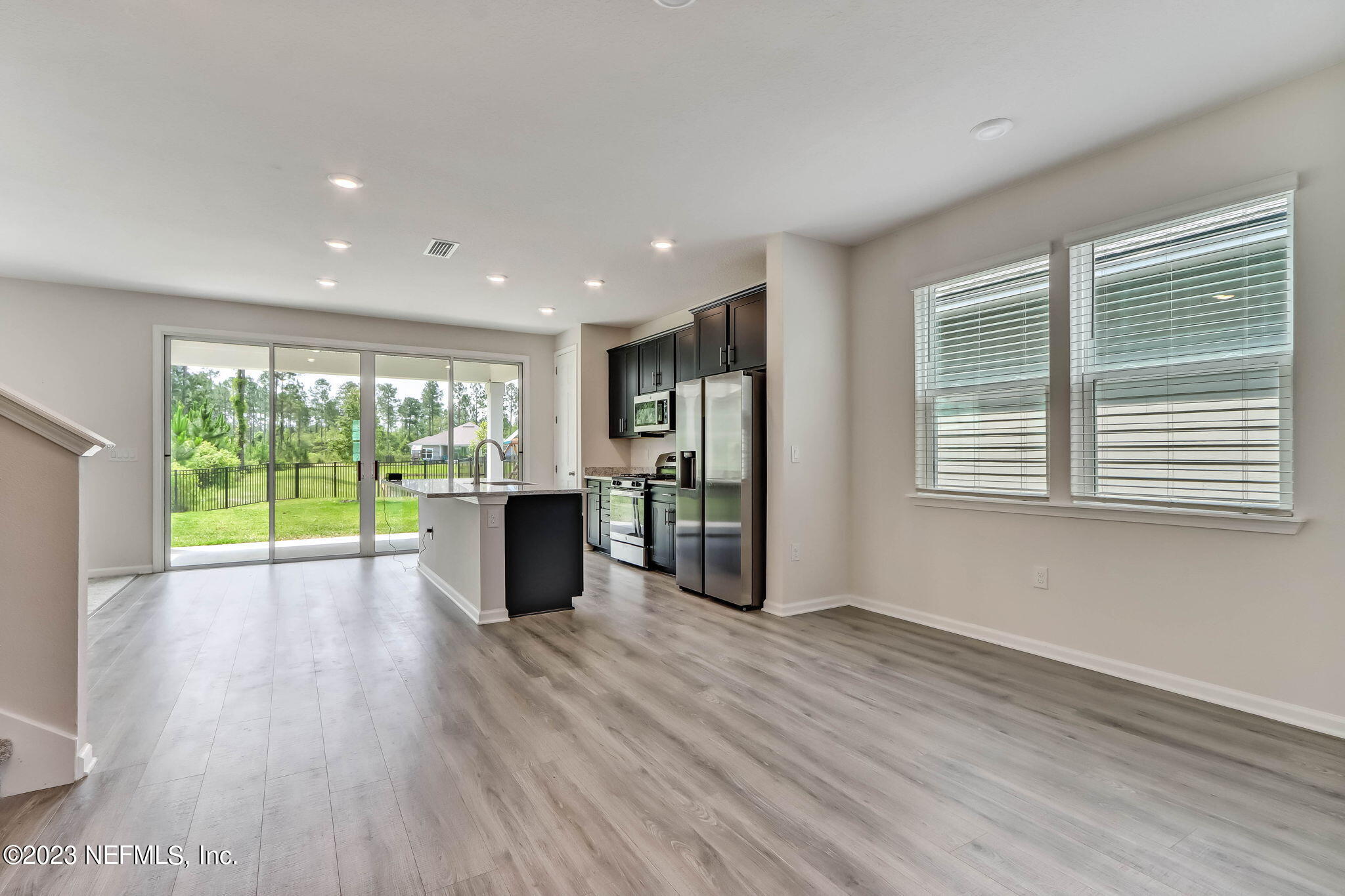 75944 Saffron Lane Yulee, FL 32097 - Photo 5 of 79 a view of an empty room with wooden floor and a window
