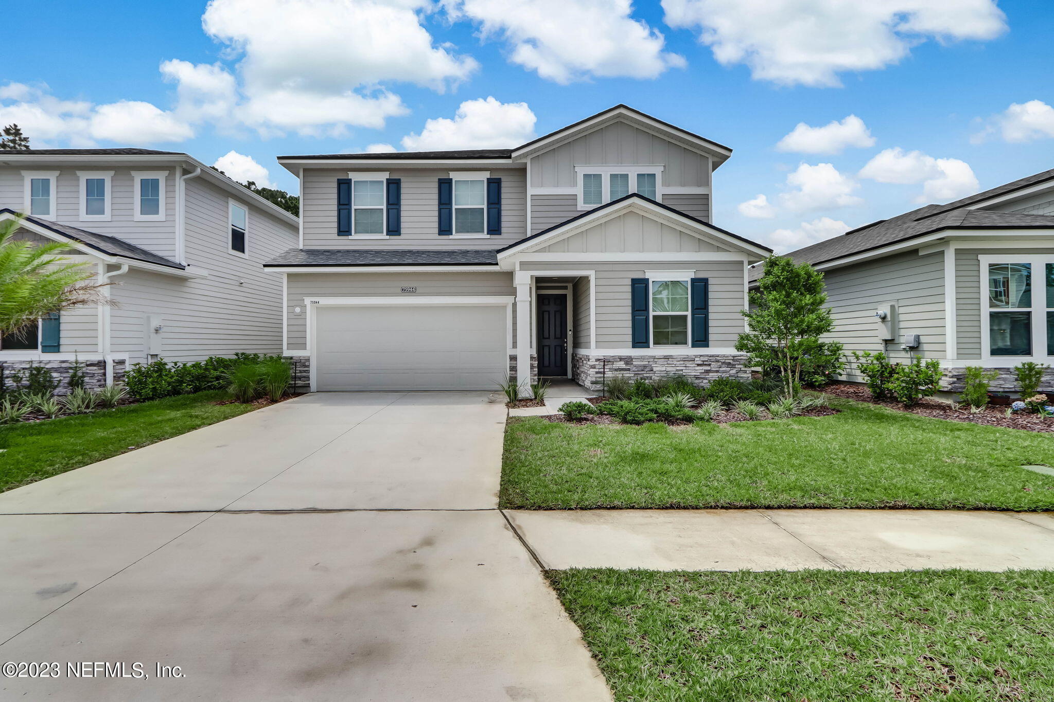 75944 Saffron Lane Yulee, FL 32097 - Photo 78 of 79 a front view of a house with a yard and garage