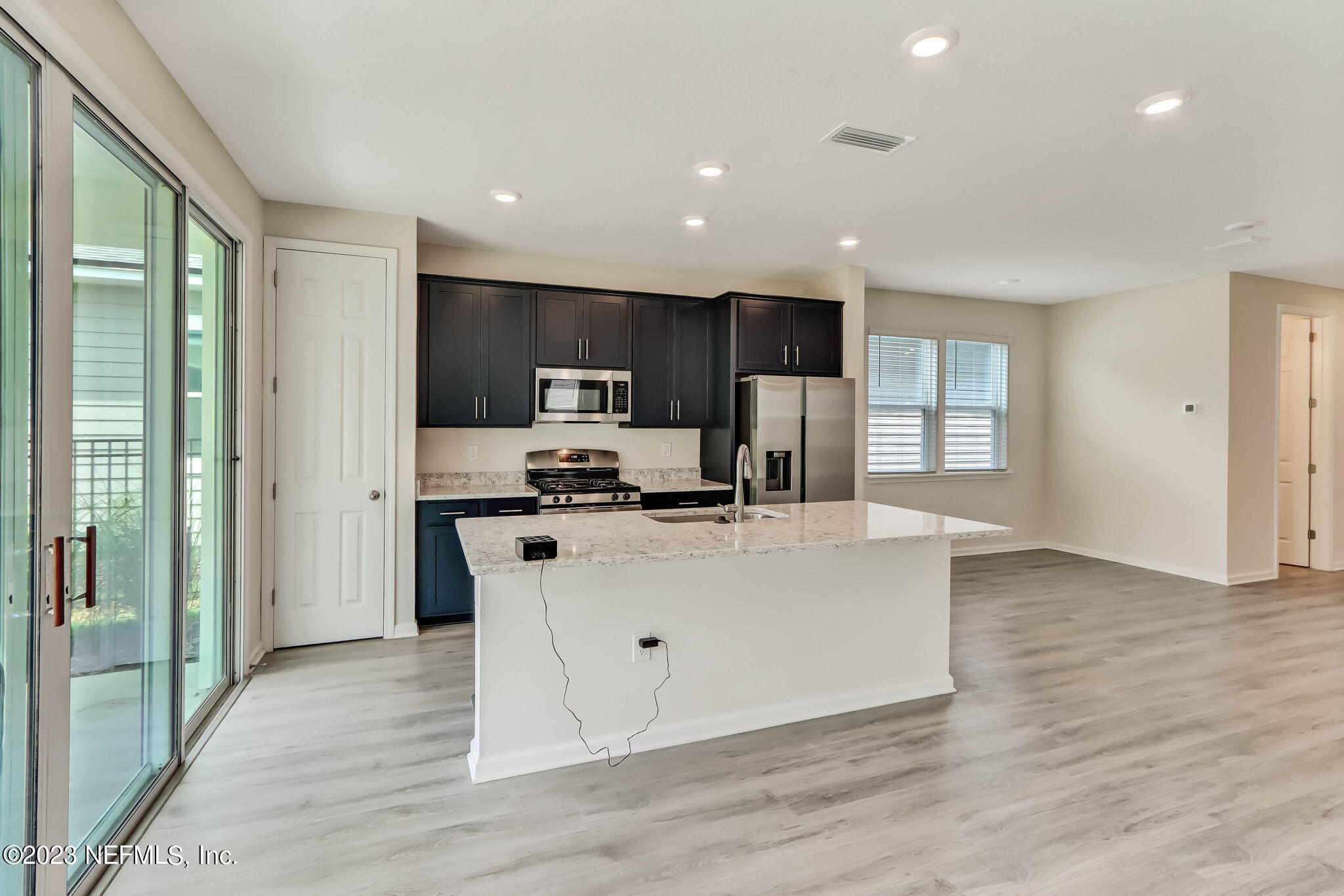 75944 Saffron Lane Yulee, FL 32097 - Photo 8 of 79 a living room with stainless steel appliances granite countertop furniture wooden floor and a view of kitchen