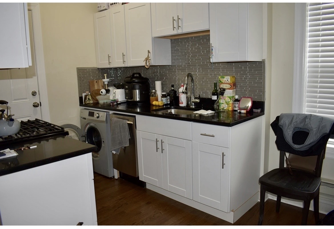 3817 North Greenview Avenue, Unit 3W Chicago, IL 60613 - Photo 3 of 10 a kitchen with stainless steel appliances kitchen island granite countertop a sink stove and cabinets