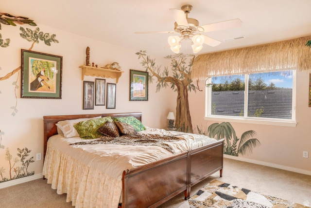 48 South Sage Road Pine Valley, UT 84781 - Photo 38 of 61 Hardwood bed frame with footboard, ceiling fan with integrated lighting, wall-mounted shelving, and a large window with white trim