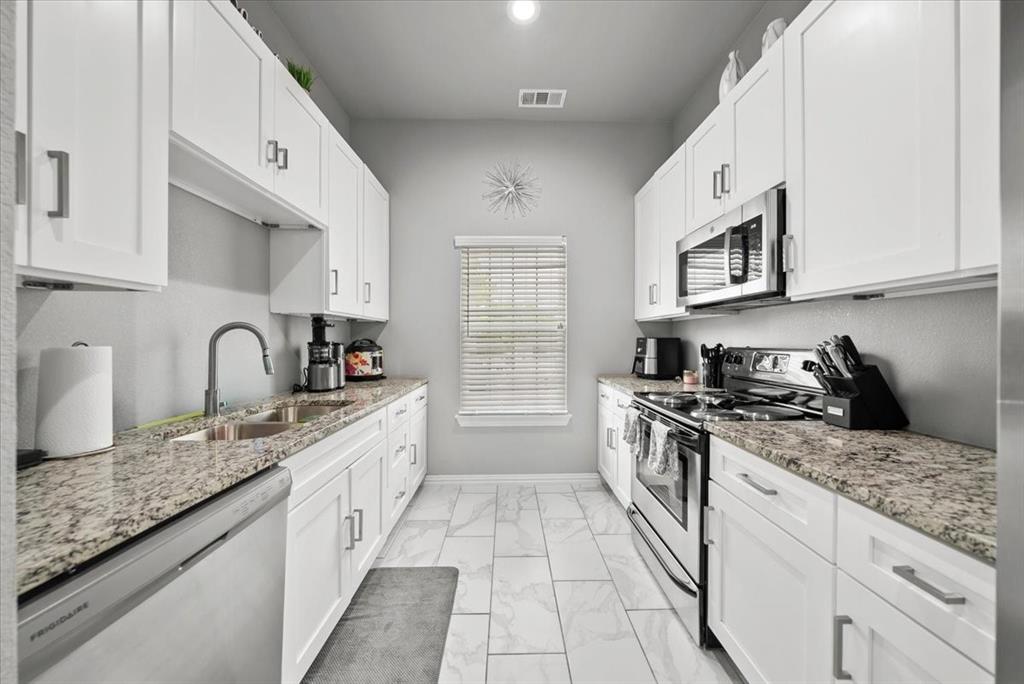 5312 Black Hawk Street Dallas, TX 75212 - Photo 11 of 24 a kitchen with granite countertop a sink stove top oven and cabinets