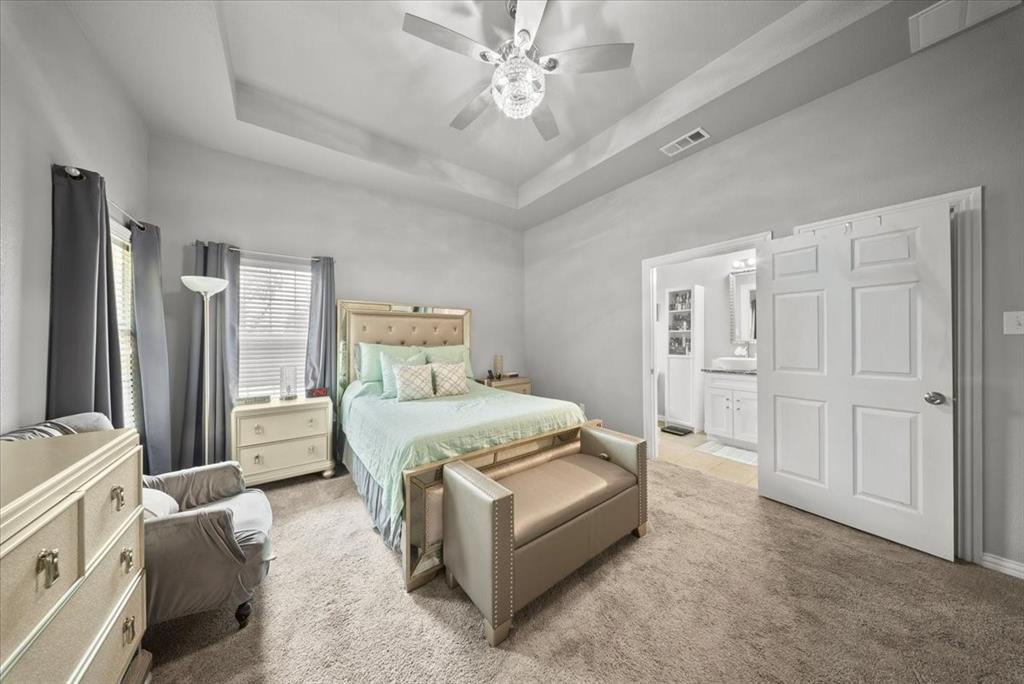 5312 Black Hawk Street Dallas, TX 75212 - Photo 12 of 24 a spacious bedroom with a bed and a chandelier