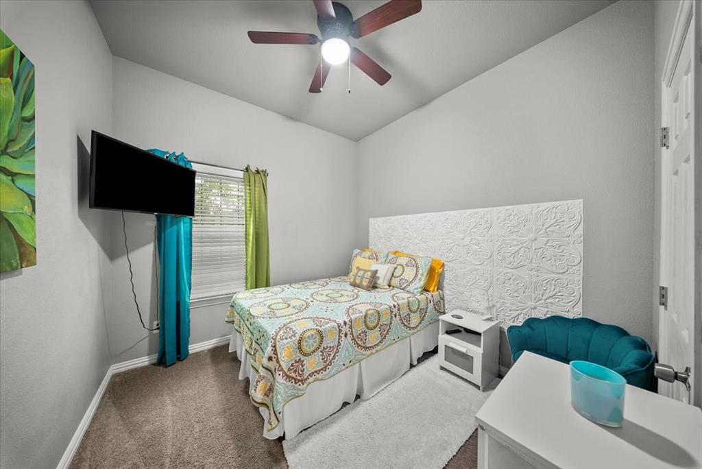 5312 Black Hawk Street Dallas, TX 75212 - Photo 15 of 24 a bedroom with a bed and a flat screen tv