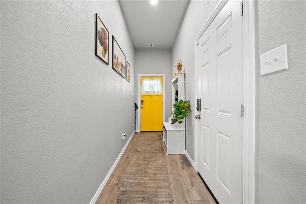 5312 Black Hawk Street Dallas, TX 75212 - Photo 18 of 24 a view of a hallway with wooden floor and staircase