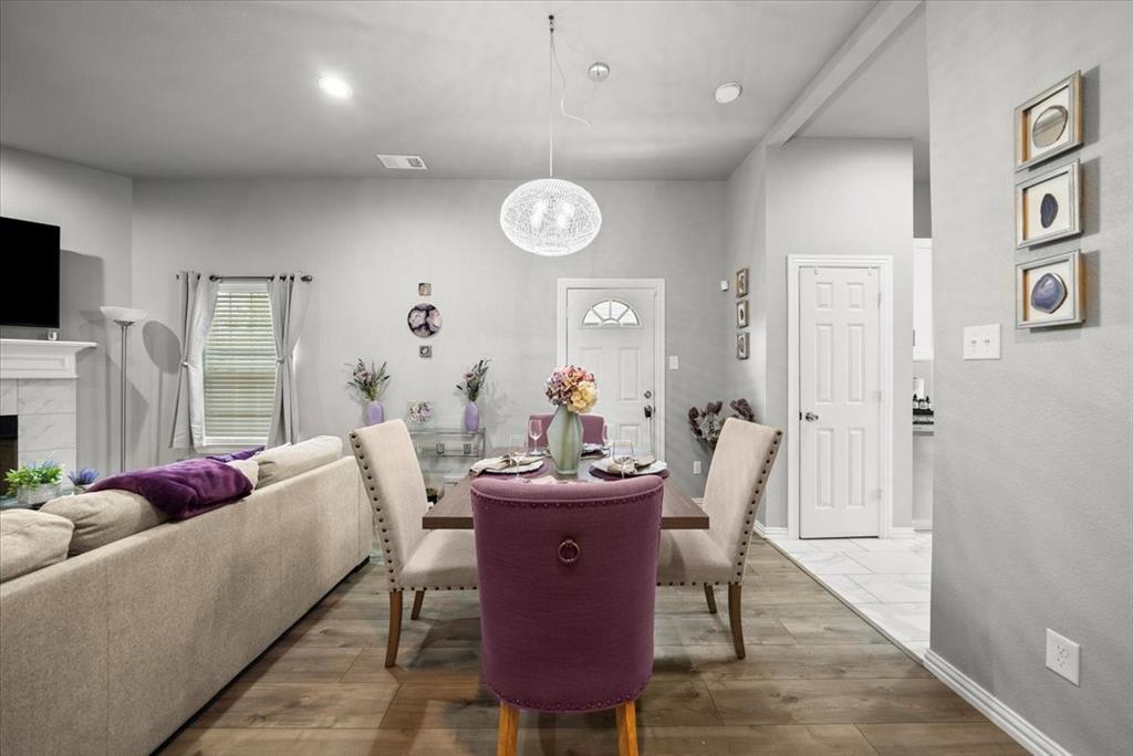 5312 Black Hawk Street Dallas, TX 75212 - Photo 22 of 24 a living room with furniture a fireplace and a flat screen tv