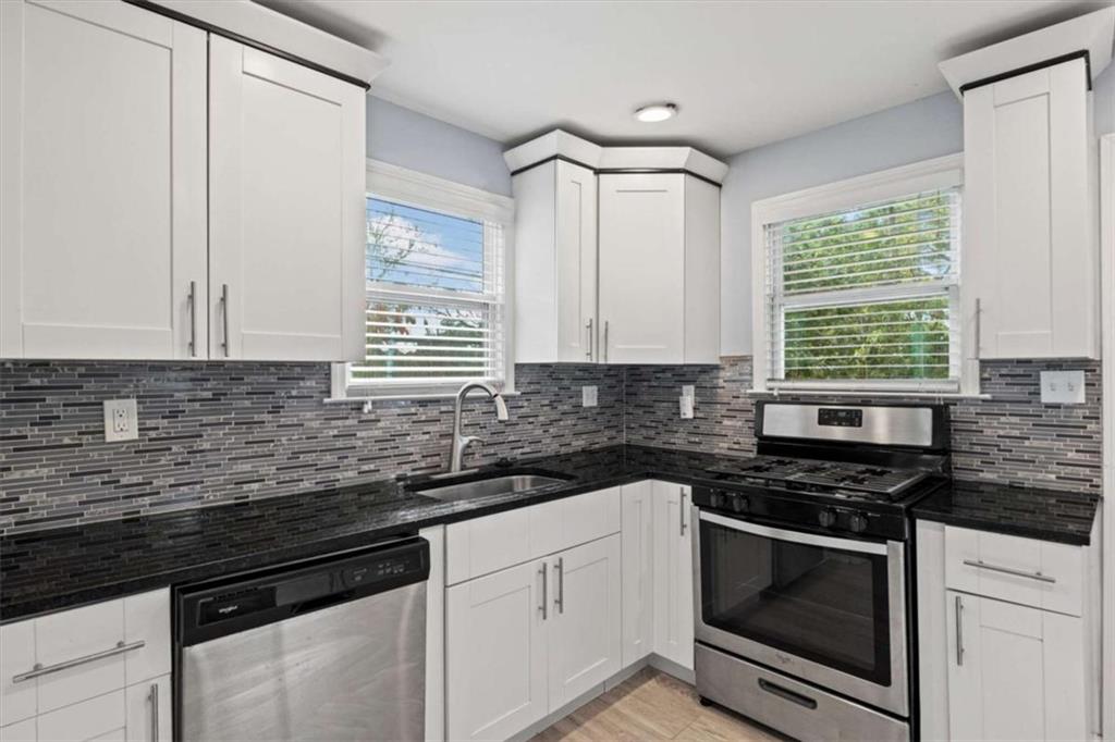 701 Daniel Avenue Decatur, GA 30032 - Photo 25 of 37 a kitchen with granite countertop cabinets stainless steel appliances a sink and a window