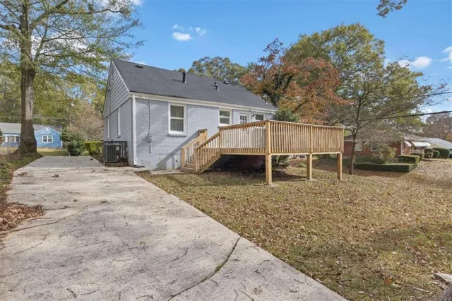a backyard of a house with table and chairs