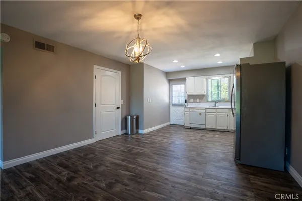 a view of a kitchen with a sink and dishwasher wooden floor