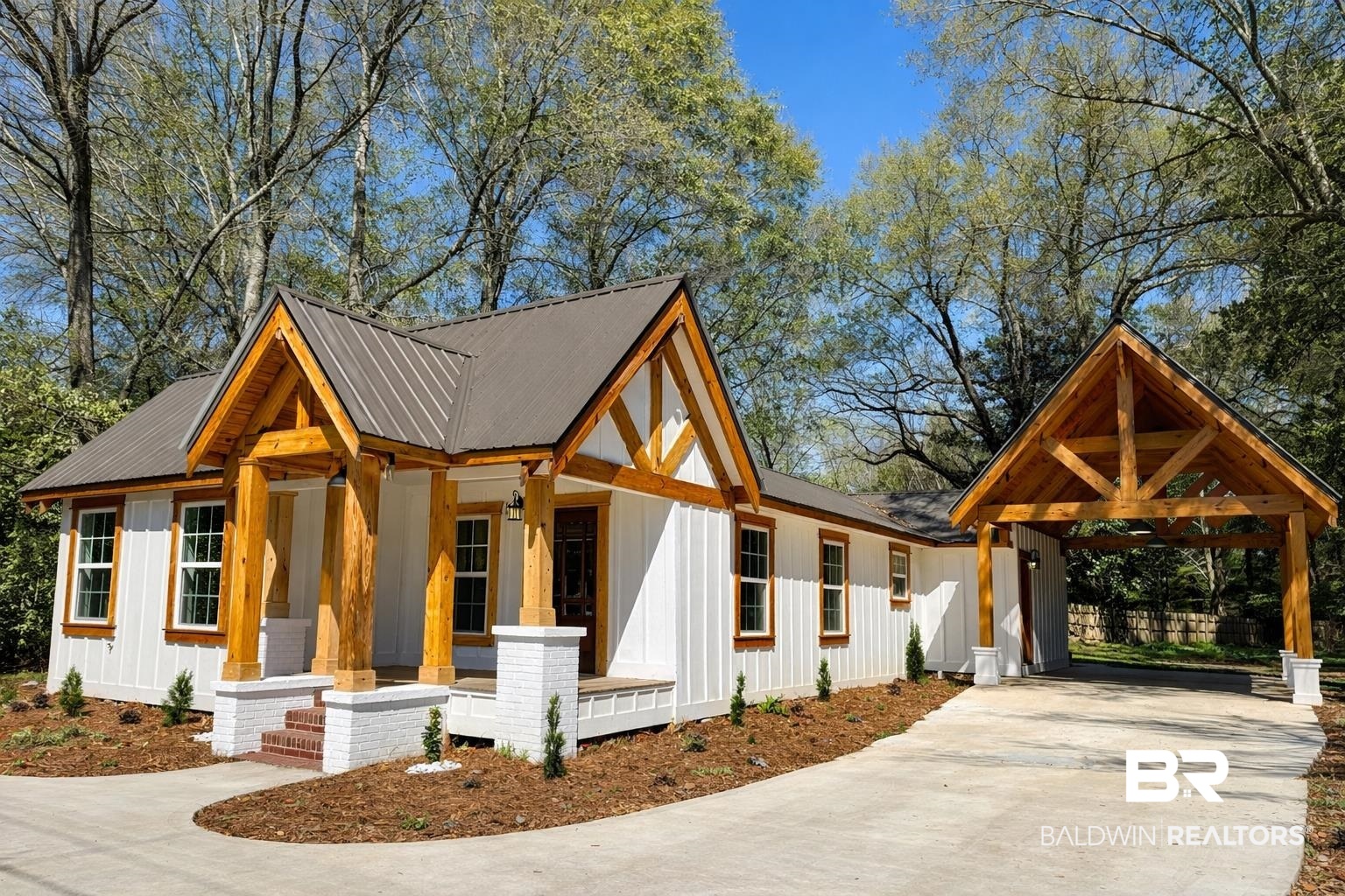 613 Forrest Avenue Brewton, AL 36426 - Photo 22 of 22 Modern farmhouse with board and batten siding, concrete driveway, a metal roof, and a carport