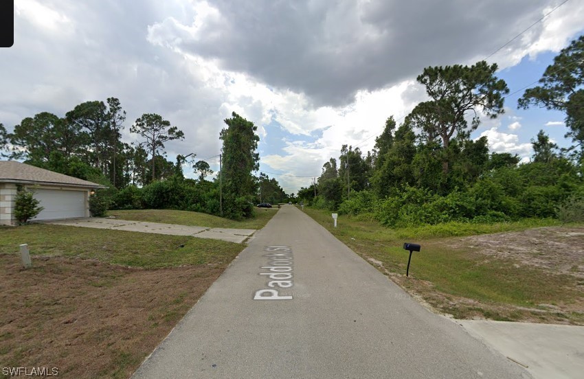 421 Paddock Street Lehigh Acres, FL 33974 - Photo 3 of 5 a view of a street with a house in the background
