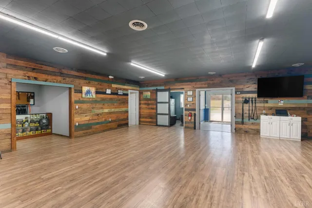 a view of a hallway with wooden floor and furniture