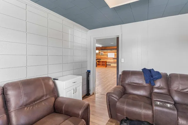 a view of a room with wooden floor and windows