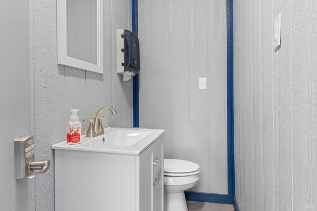 a view of an empty room with a window and a flat screen tv