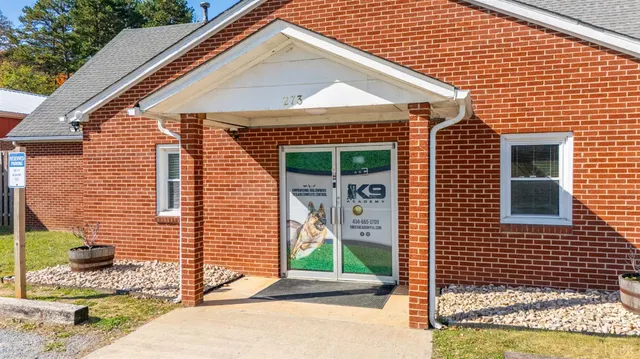 a view of a room with a large window and wooden floor