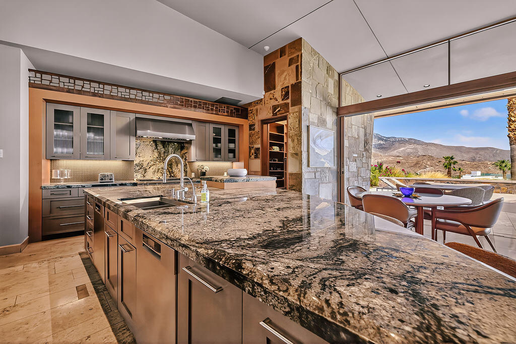 9 Rockcrest Drive Rancho Mirage, CA 92270 - Photo 12 of 64 a kitchen with a stove and a refrigerator