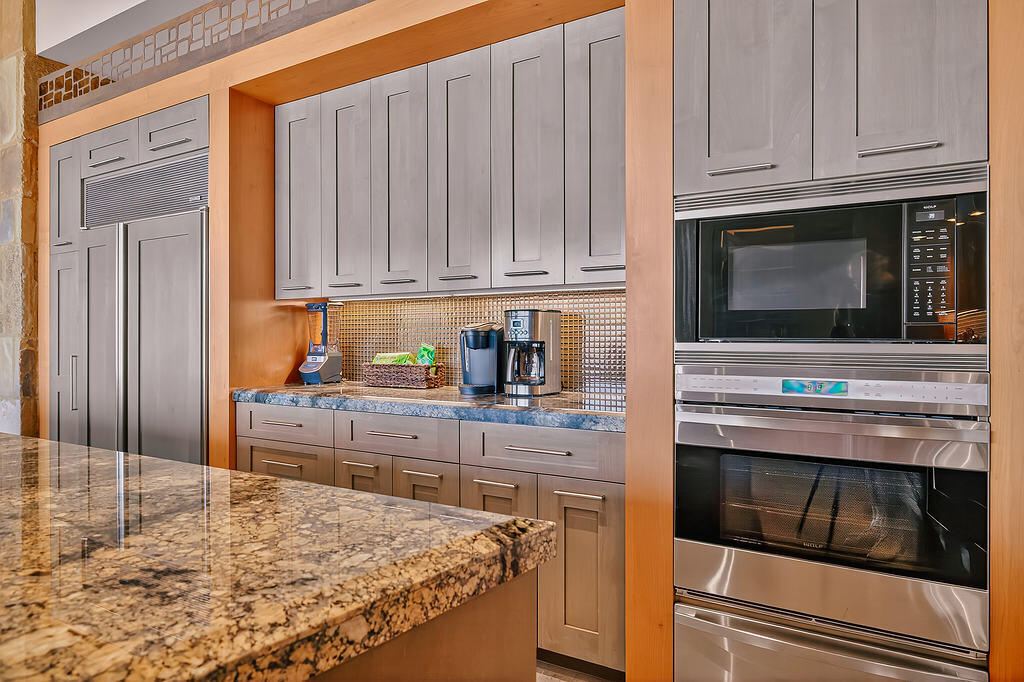 9 Rockcrest Drive Rancho Mirage, CA 92270 - Photo 14 of 64 a kitchen with stainless steel appliances granite countertop a stove microwave and cabinets