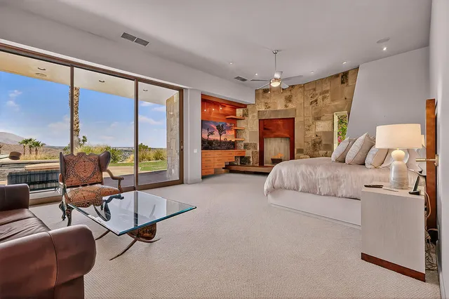 a bed room with a bed and a large window