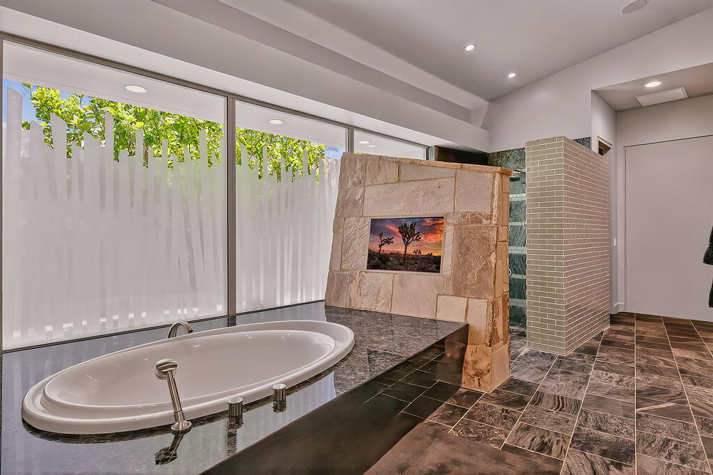 9 Rockcrest Drive Rancho Mirage, CA 92270 - Photo 32 of 64 a room with a table and a flat screen tv