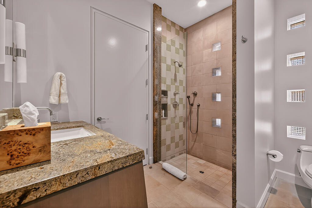 9 Rockcrest Drive Rancho Mirage, CA 92270 - Photo 37 of 64 a bathroom with a granite countertop sink mirror and shower