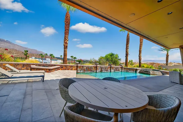 a view of a swimming pool with an outdoor seating