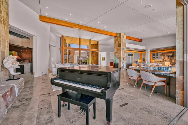 a living room with furniture a rug and a large window