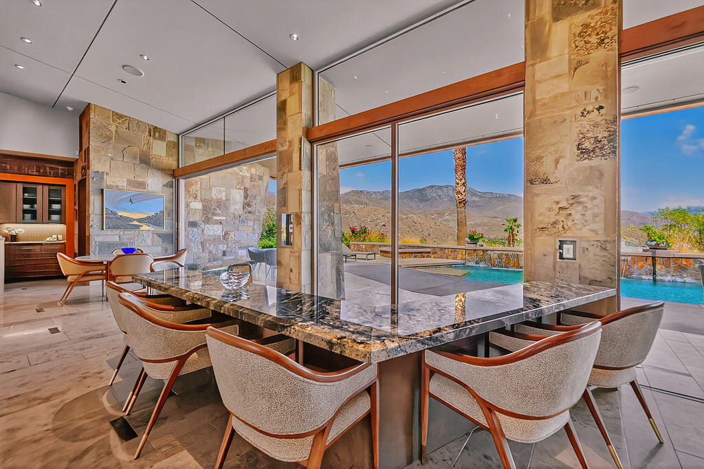 9 Rockcrest Drive Rancho Mirage, CA 92270 - Photo 8 of 64 a view of a dining room with furniture a fireplace and large windows