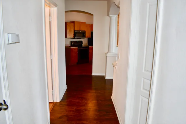 a view of a hallway with wooden floor