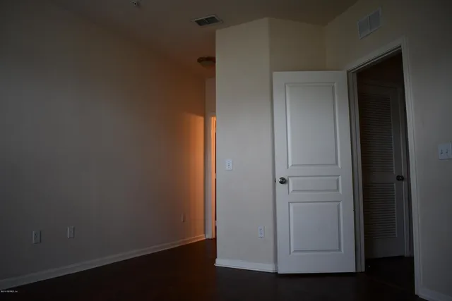 an empty room with wooden floor