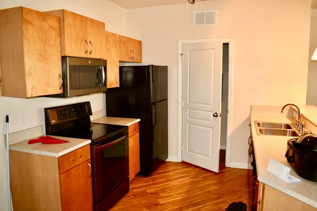 a kitchen with a refrigerator and a stove