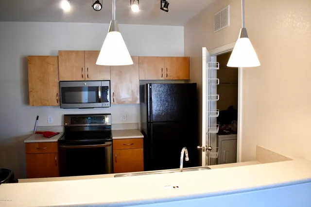 a kitchen with a refrigerator and a stove
