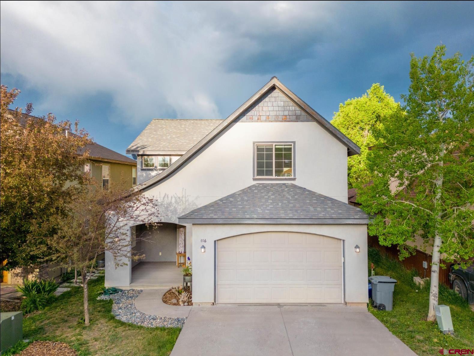 416 Amy Way Ridgway, CO 81432 - Photo 1 of 26 a front view of a house with garden