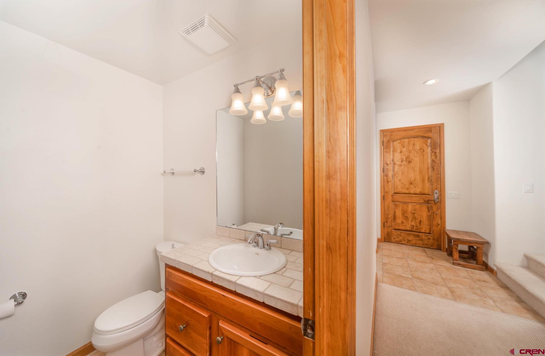 416 Amy Way Ridgway, CO 81432 - Photo 13 of 26 a bathroom with a granite countertop sink toilet and shower