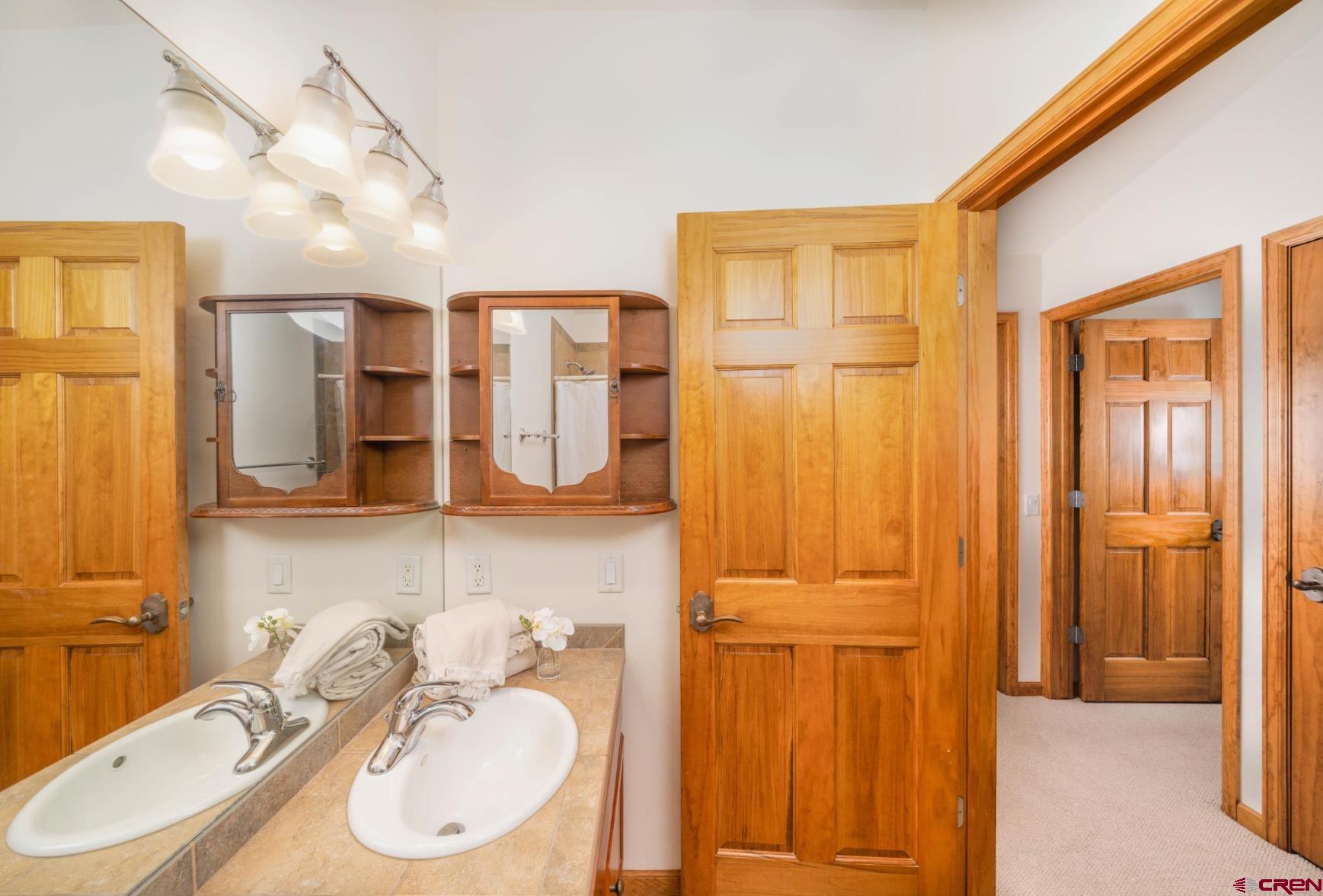 416 Amy Way Ridgway, CO 81432 - Photo 20 of 26 a bathroom with a sink a mirror and a shower