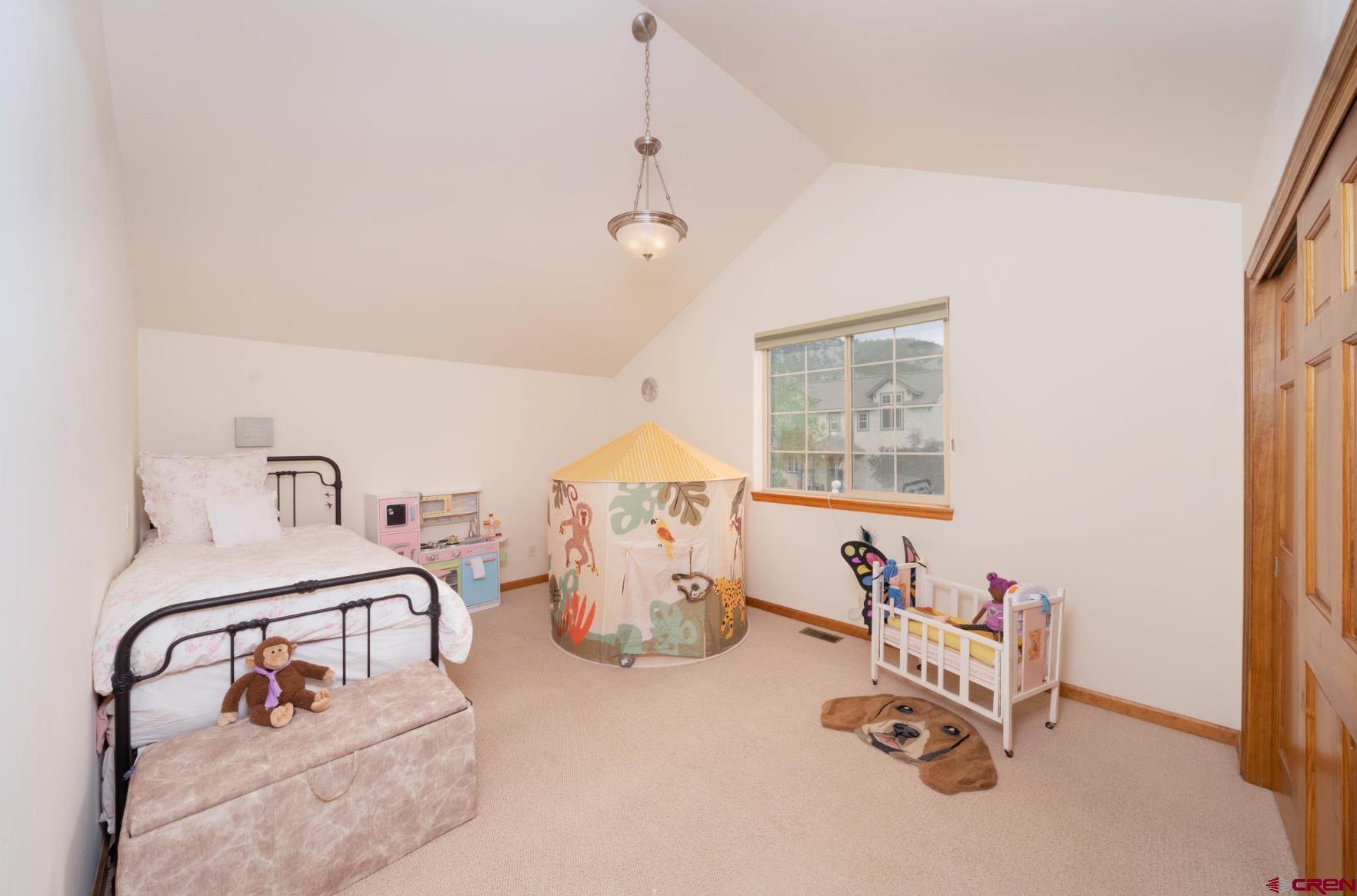 416 Amy Way Ridgway, CO 81432 - Photo 21 of 26 a bedroom with furniture and a window