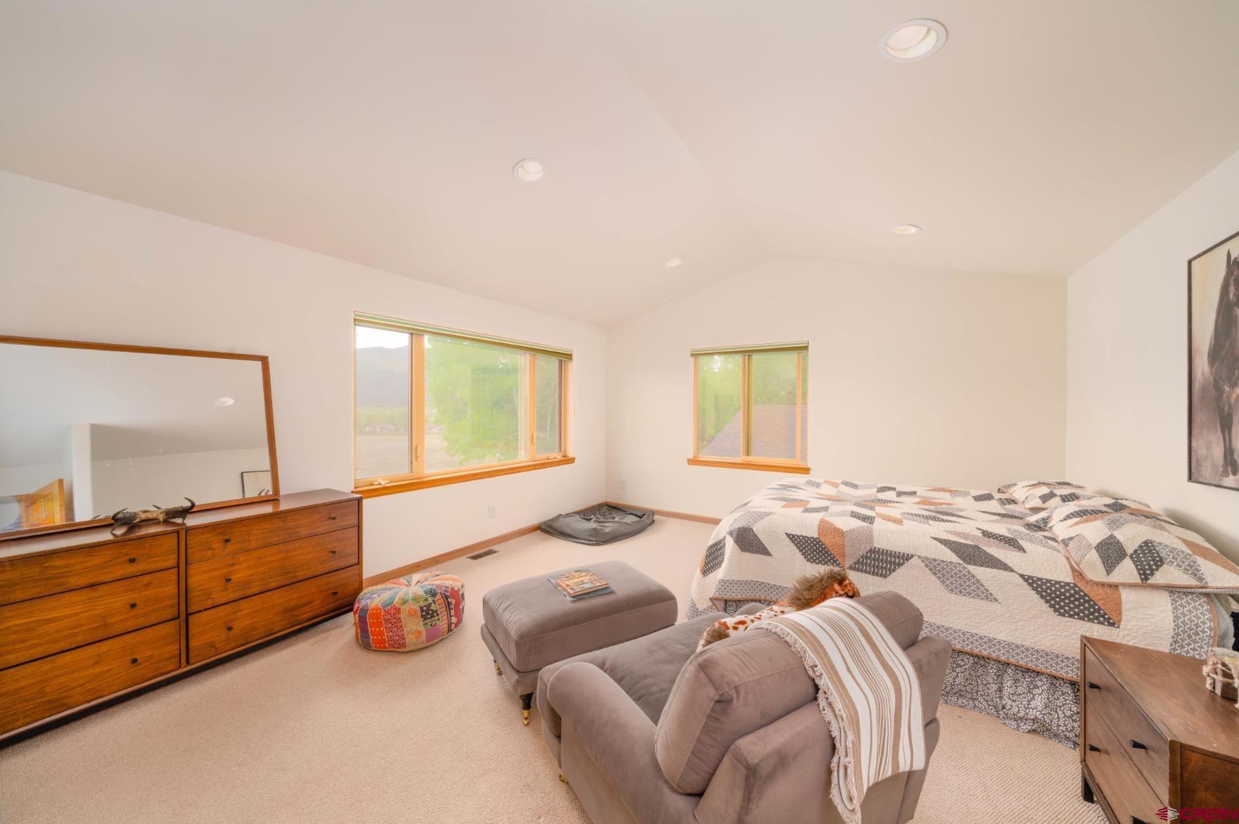 416 Amy Way Ridgway, CO 81432 - Photo 23 of 26 a spacious bedroom with two beds and painting on the wall