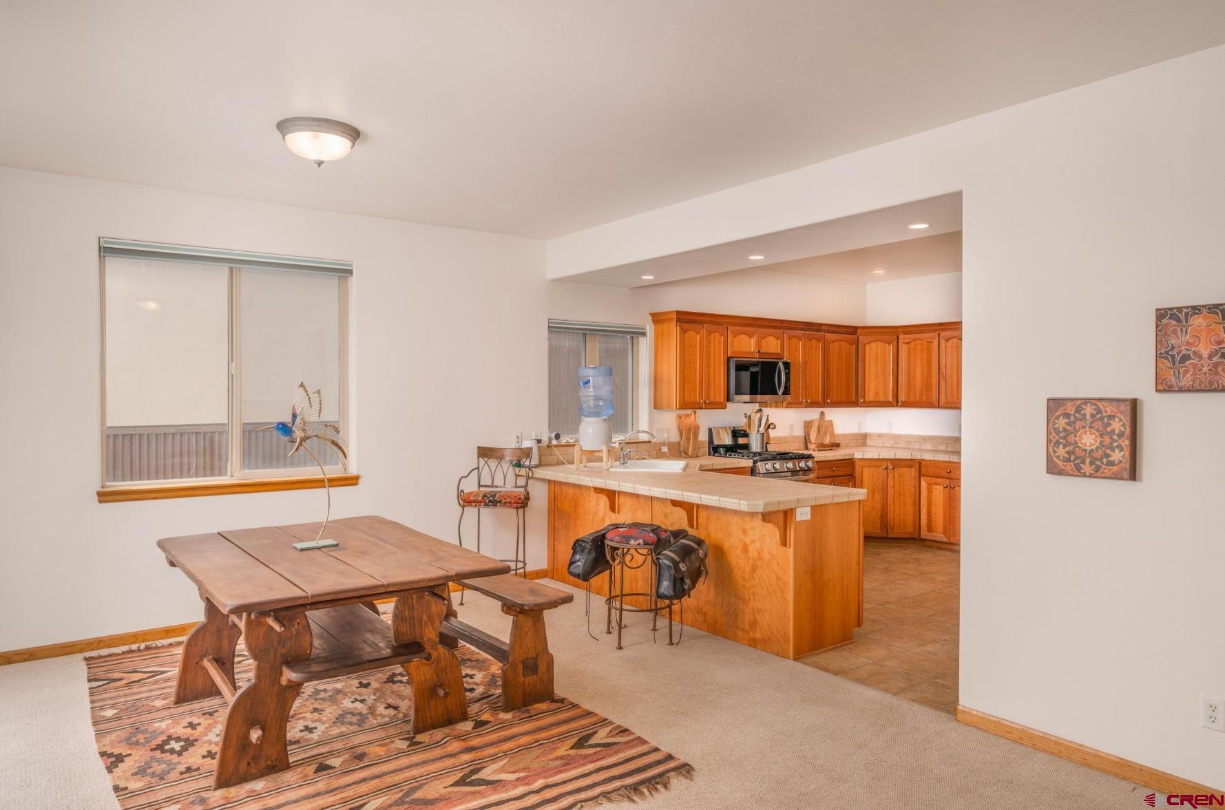 416 Amy Way Ridgway, CO 81432 - Photo 7 of 26 a view of a dining room with furniture and a window