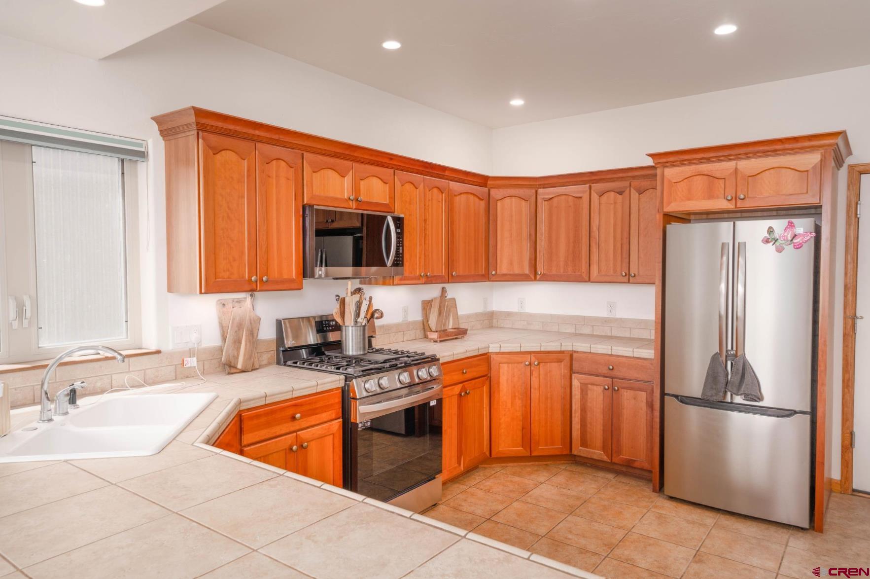 416 Amy Way Ridgway, CO 81432 - Photo 8 of 26 a kitchen with stainless steel appliances granite countertop a refrigerator stove and sink